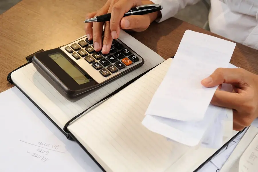 closeup-woman-calculating-bills-